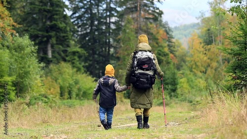 Wallpaper Mural Young woman mother with little son walking tracking in the mountains enjoying beautiful autumn nature. Hiker healthy sport lifestyle activity. Back view. Traveling family life. Torontodigital.ca