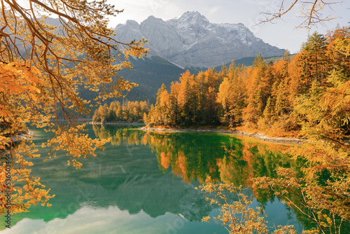 Autumn colors in fall at lake Eibsee. Alpine landscape with German Alps mountain Zugspitze reflected in the Eibsee lake. Garmisch-Partenkirchen  Bavarian alps  Germany  Europe. Impressive View