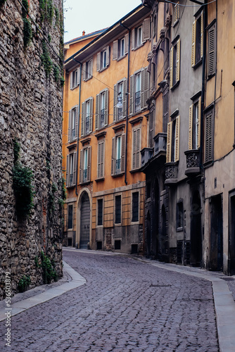 Fototapeta Naklejka Na Ścianę i Meble -  Paved road with appartment buildings and architecture in Bergamo, Italy