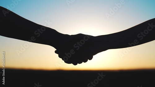 handshake farmers silhouette. agriculture business concept. close-up farmers hands silhouette shaking hands silhouette making a contract agreement. farmers negotiations in sun agriculture business