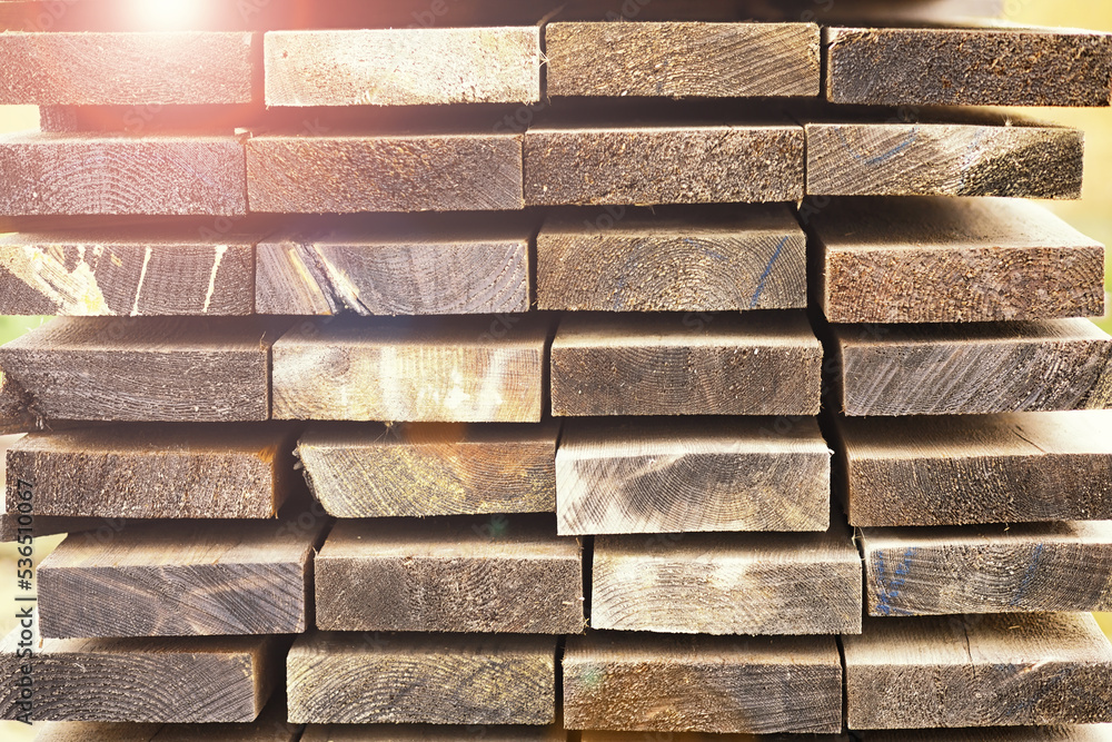 Stack of fresh pine boards in a sawmill warehouse. Harvesting, sale of lumber for construction Stack of fresh pine boards in a sawmill warehouse. Harvesting, sale of lumber for construction
