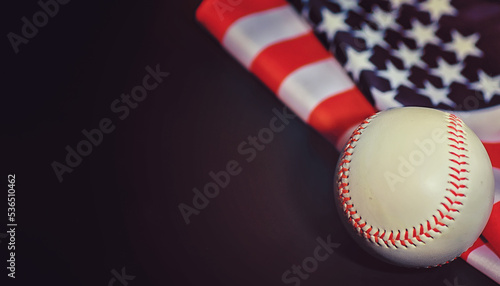 American traditional sports game. Baseball. Concept. Baseball ball and bats on a table with american flag. photo