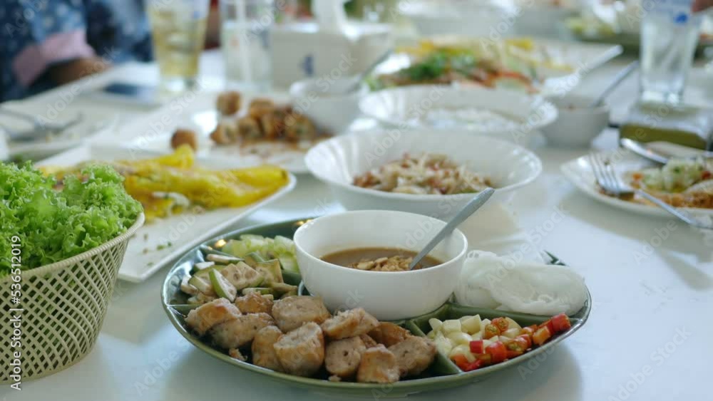 Group of friends enjoying meal at restaurant together , vietnamese style food Group of friends enjoying meal at restaurant together , vietnamese style food