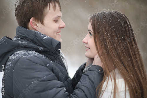 pair of lovers on a date winter afternoon in a snow blizzard
