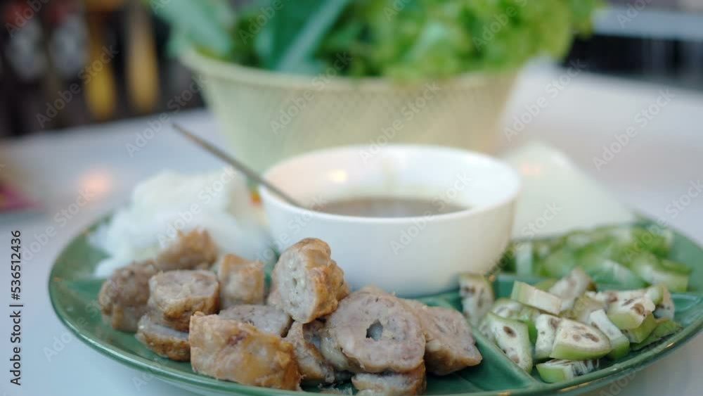 Group of friends enjoying meal at restaurant together , vietnamese style food Group of friends enjoying meal at restaurant together , vietnamese style food