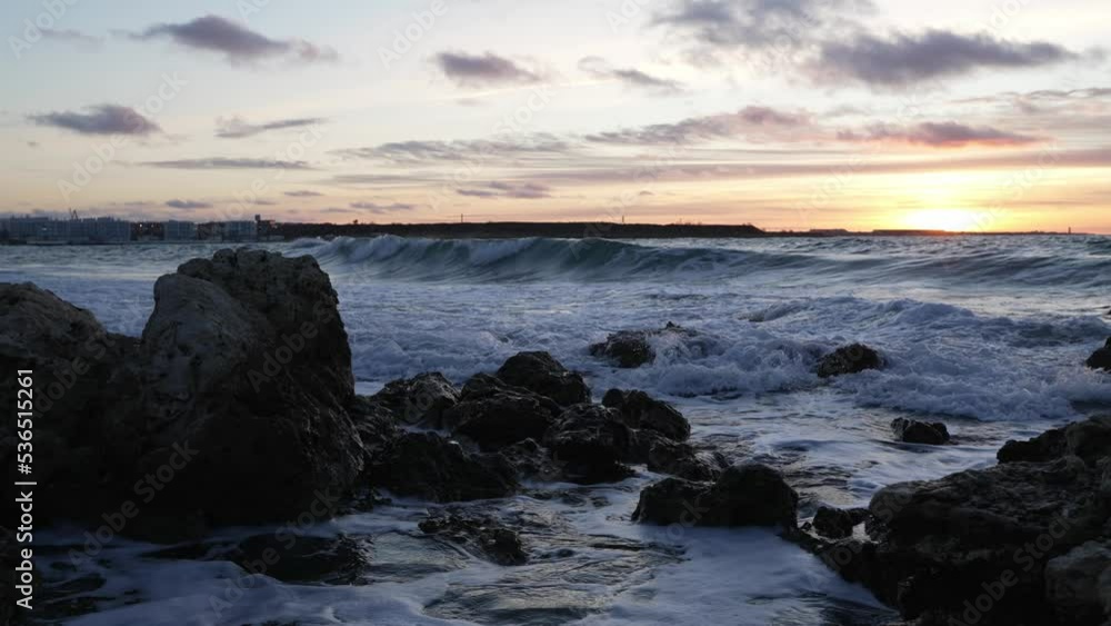 The power of the ocean. A beautiful scene of the sea waves crashing on the rocks at sunset. Relaxing sea. Waves on the sea at sunset The power of the ocean. A beautiful scene of the sea waves crashing on the rocks at sunset. Relaxing sea. Waves on the sea at sunset