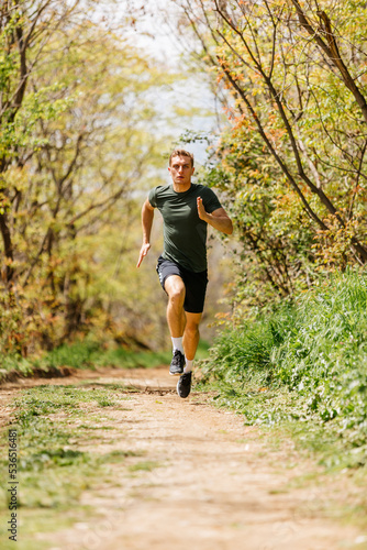 Sport man running. Portrait of runner man jogging in park. Sport workout outdoor. Athlete training run exercise