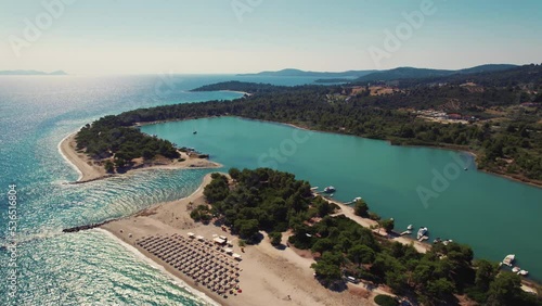 Port Glarokavos, Paliouri, Kassandra in Greece. Sunny perfect summer weather. Aerial perspective of turquoise water, touristic beaches and clear blue sky. High quality 4k footage photo