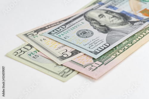 5, 20, 50, 100 dollars banknotes at different angles. Close up of dollars on white background.