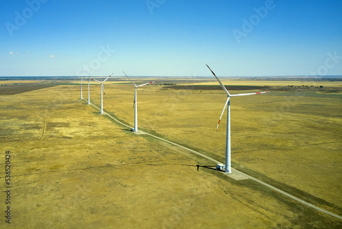 wind power plant in the steppe against the blue sky shooting from a drone © сергей тарануха