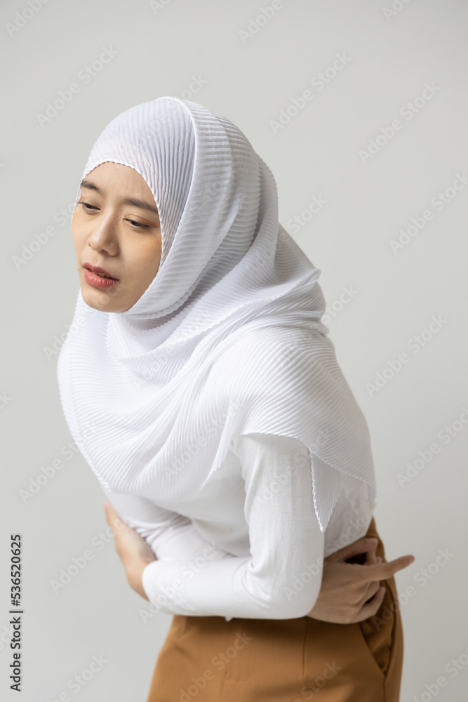 muslim woman suffering from stomachache, menstrual period cramp, abdominal pain, food poisoning, gastritis, acid reflux muslim woman suffering from stomachache, menstrual period cramp, abdominal pain, food poisoning, gastritis, acid reflux