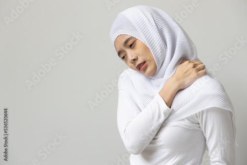 Muslim woman having shoulder or neck pain