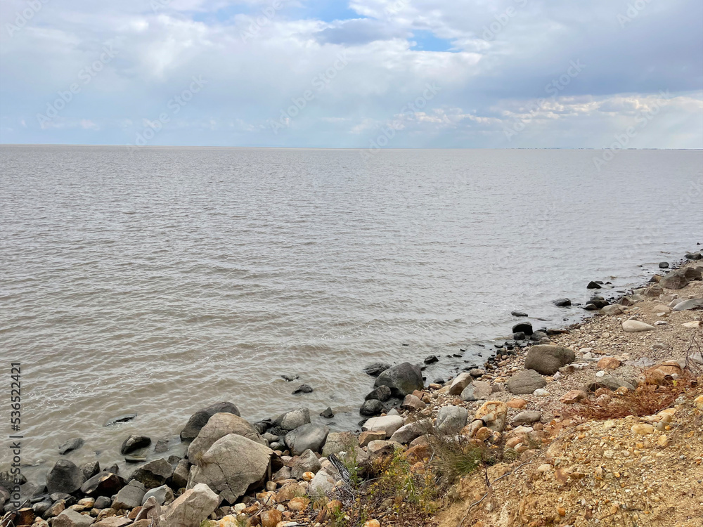 Rocky section of the shore of Lake Khanka in autumn. Russia, Primorsky Krai