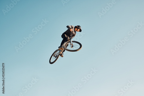 Motorcycle stunt, man cycling in air jump on blue sky mock up for sports action performance, fitness training or outdoor bike performance. Professional sports person with bmx bicycle adventure mockup