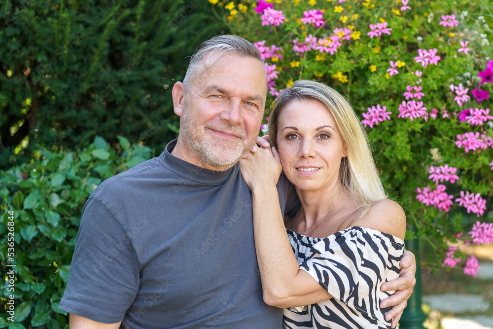 Fototapeta premium Happy middle aged couple posing arm in arm
