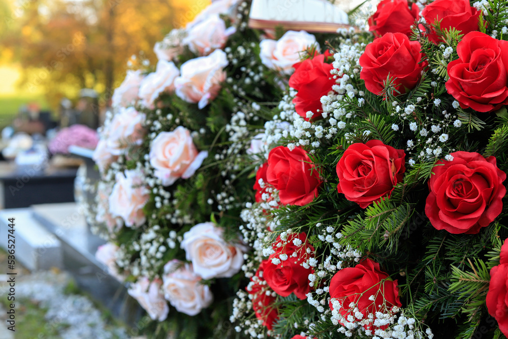 Funeral wreath with red roses. Flower decoration for the grave