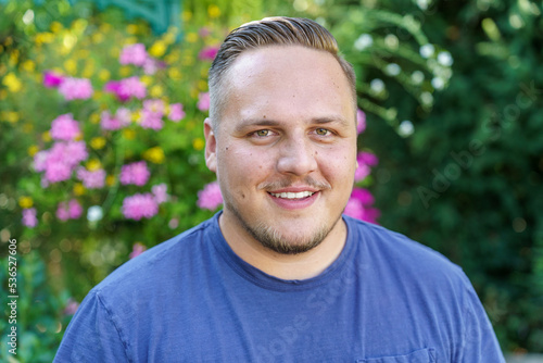 Friendly smiling young man with mustache and beard