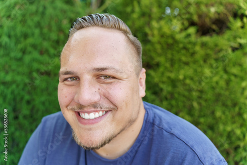 Happy friendly young man with a beaming smile