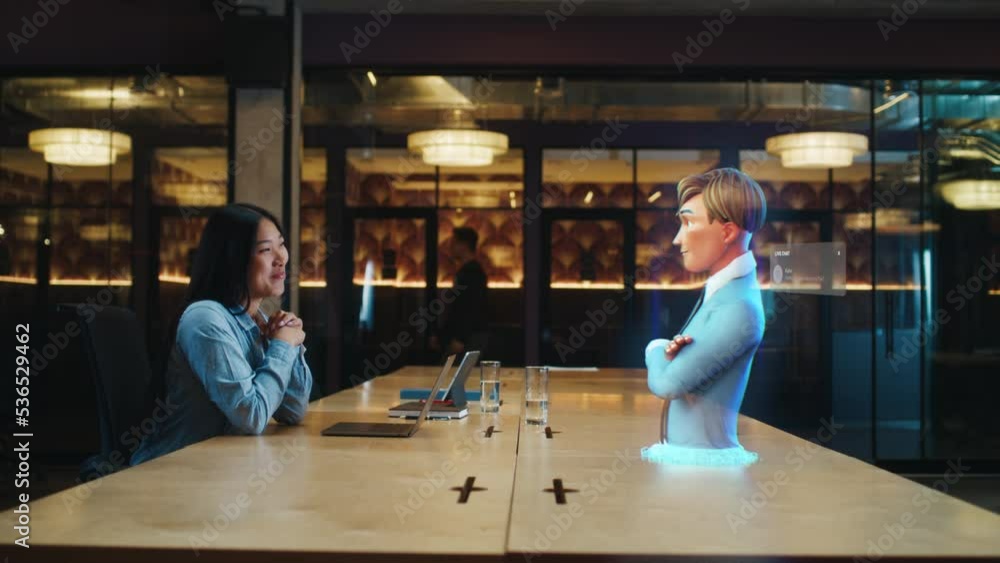 Video call chat conference of an asian woman using hologram technology. Conversing with a cartoon character avatar of young man. Advanced technology. VFX. Augmented reality.
