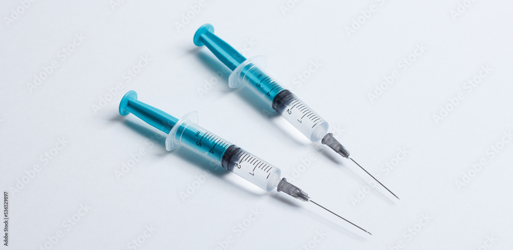 Medical syringe on a white background. A syringe for injection. The concept of health and beauty Medical syringe on a white background. A syringe for injection. The concept of health and beauty