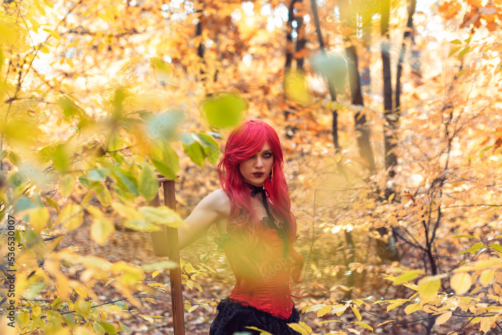 Young witch in autumn forest Young witch in autumn forest