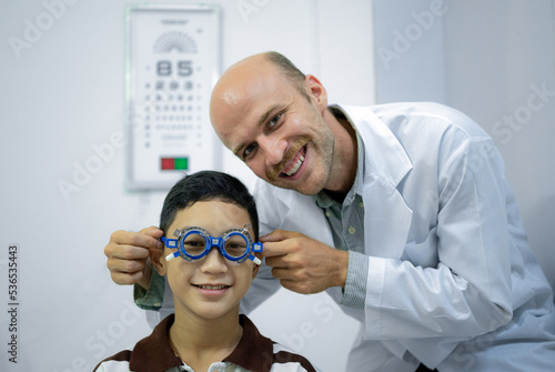 Boy has his eyes checked for glasses by a specialist.