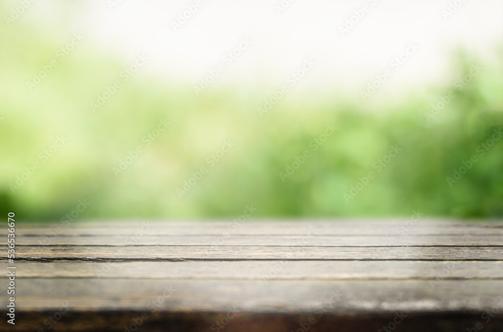 Empty Rustic Wooden Table against Green Blurred Background Empty Rustic Wooden Table against Green Blurred Background