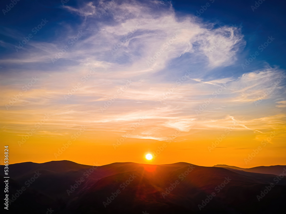 Aerial view of sunset over Ullswater lake in Lake District, a region and national park in Cumbria in northwest England