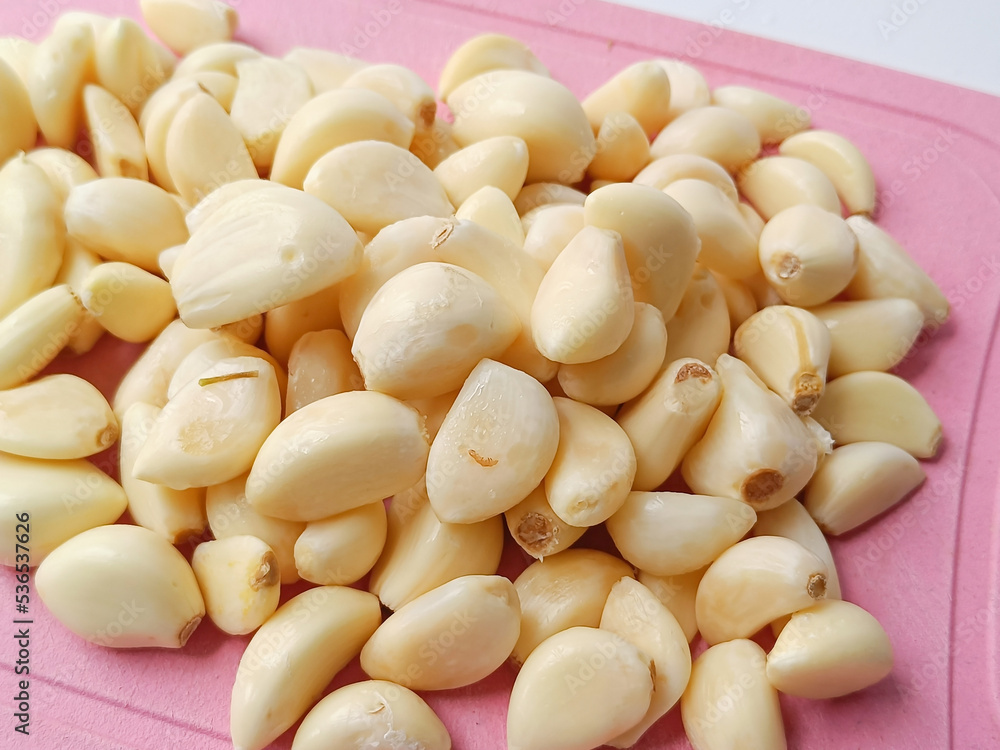 Group Fresh whole peeled garlic cloves background Group Fresh whole peeled garlic cloves background