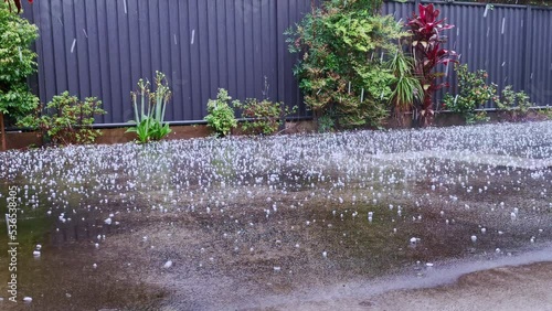 weather hail storm and heavy rain on a concrete driveway from hailstorm. Coffs Harbour, Australia. photo