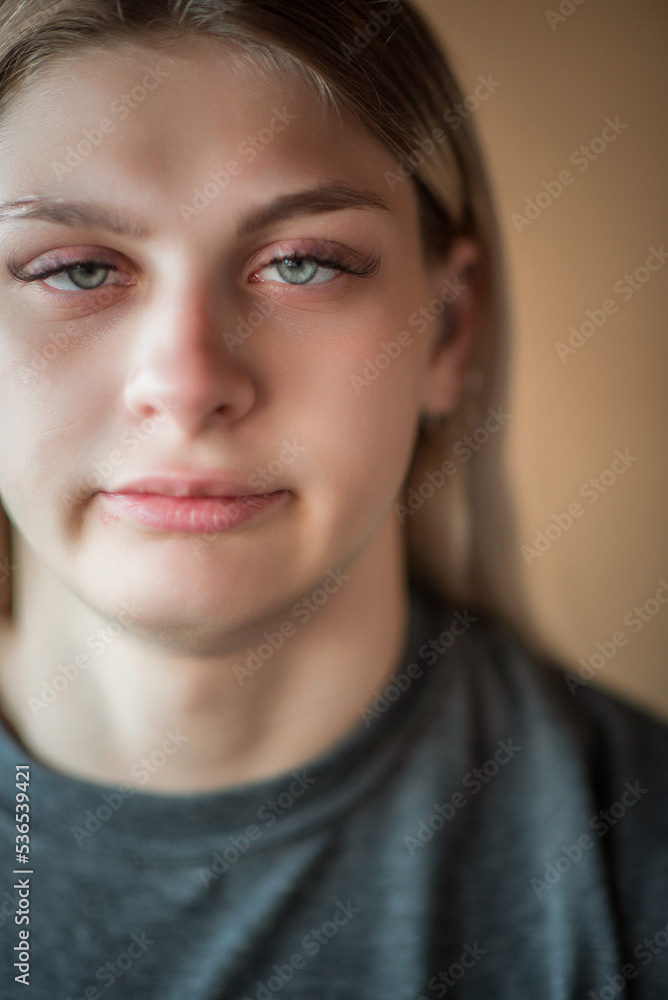 Close-up portrait of a young beautiful fair-haired girl with an interesting expression on her face. Close-up portrait of a young beautiful fair-haired girl with an interesting expression on her face.
