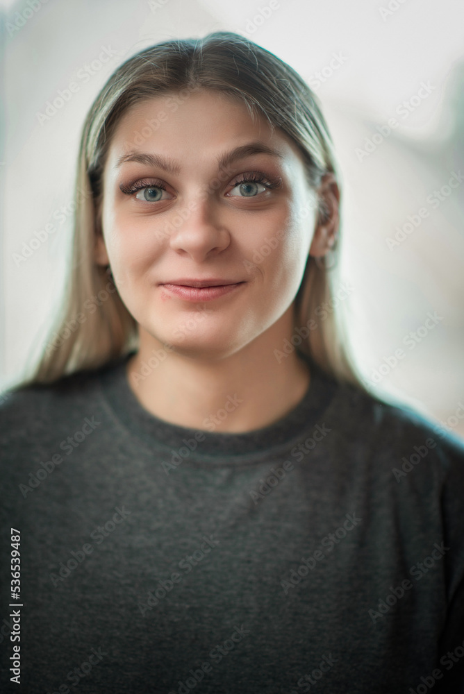 Close-up portrait of a young beautiful fair-haired girl with an interesting expression on her face. Close-up portrait of a young beautiful fair-haired girl with an interesting expression on her face.