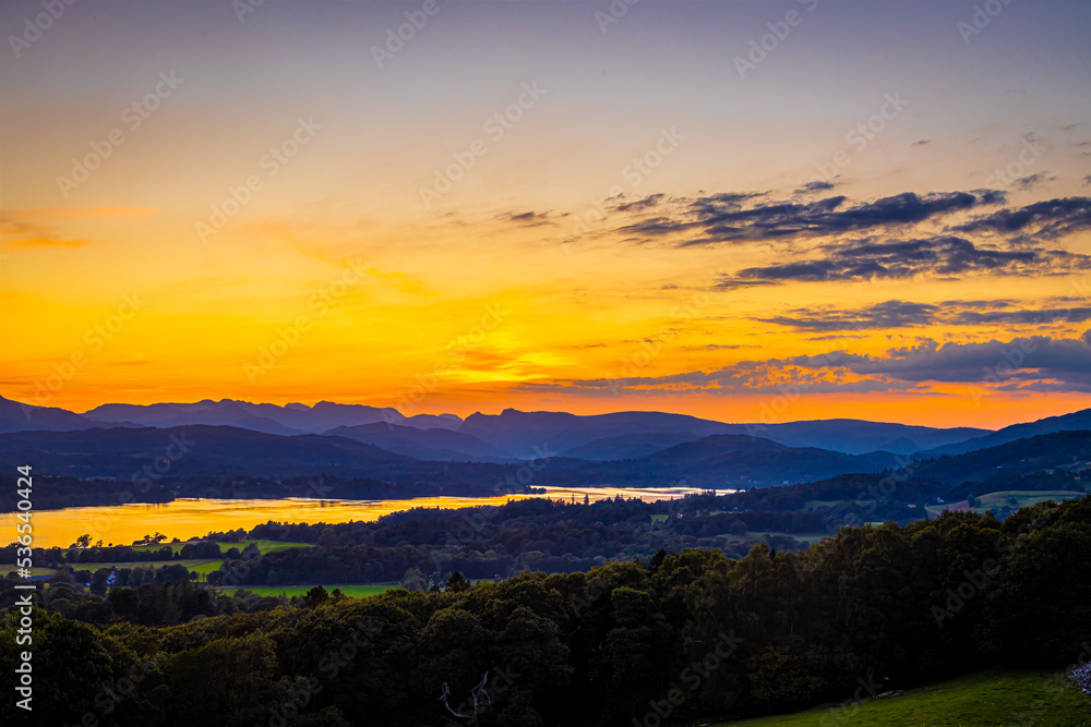 View of sunset over Windermere in Lake District, a region and national park in Cumbria in northwest England View of sunset over Windermere in Lake District, a region and national park in Cumbria in northwest England