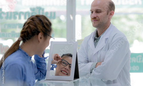Wallpaper Mural The girl tried on the glasses and looked in the mirror. Torontodigital.ca