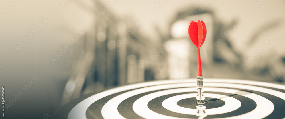 Bullseye or Bulls eye target or dartboard has dart arrow throw hitting the center of a shooting for financial business targeting planning and aim to winner goal of business concept. Bullseye or Bulls eye target or dartboard has dart arrow throw hitting the center of a shooting for financial business targeting planning and aim to winner goal of business concept.