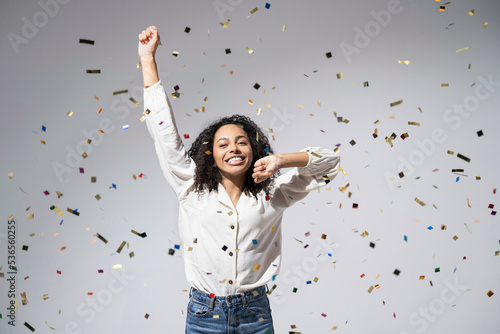Photography Joyful woman celebrating with falling confetti