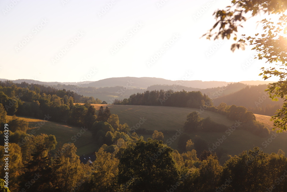 The landscape with meadows and hills during sunset near Hartmanice, Czech republic