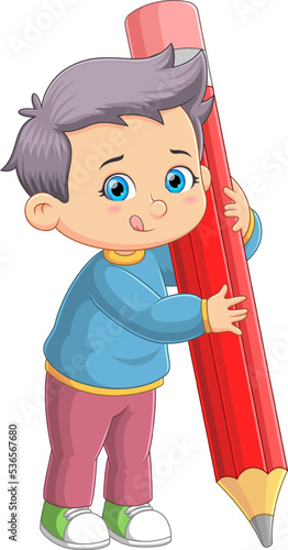 The happy student boy is holding the big pencil