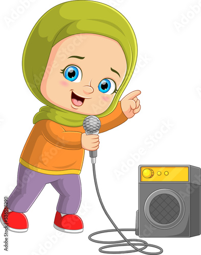 The moslem girl sings a song with the mic beside the big speaker