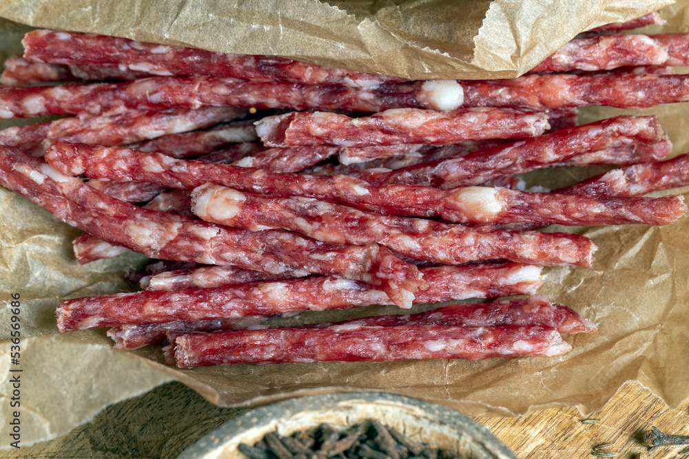 thin dried meat sausages with spices , close up