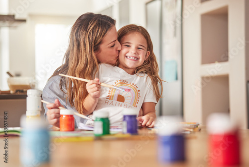 Mother, child and painting art in home using paint brush for creative activity for learning, bonding and love between mom and daughter. Woman or parent give girl kid kiss for creativity in USA house