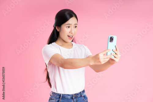 beautiful asian girl portrait, isolated on pink background