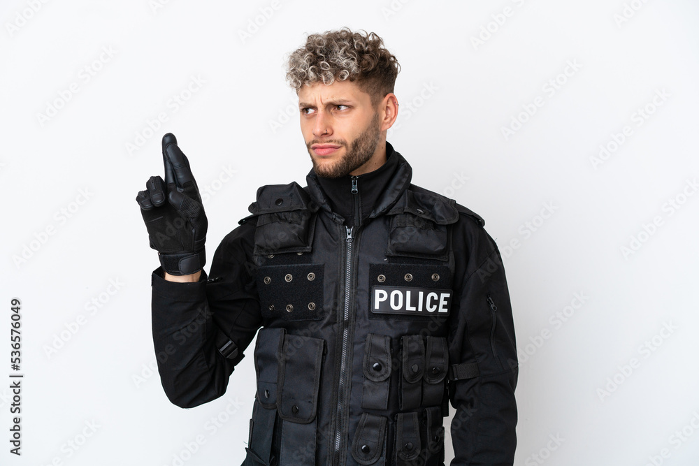SWAT caucasian man isolated on white background with fingers crossing and wishing the best SWAT caucasian man isolated on white background with fingers crossing and wishing the best