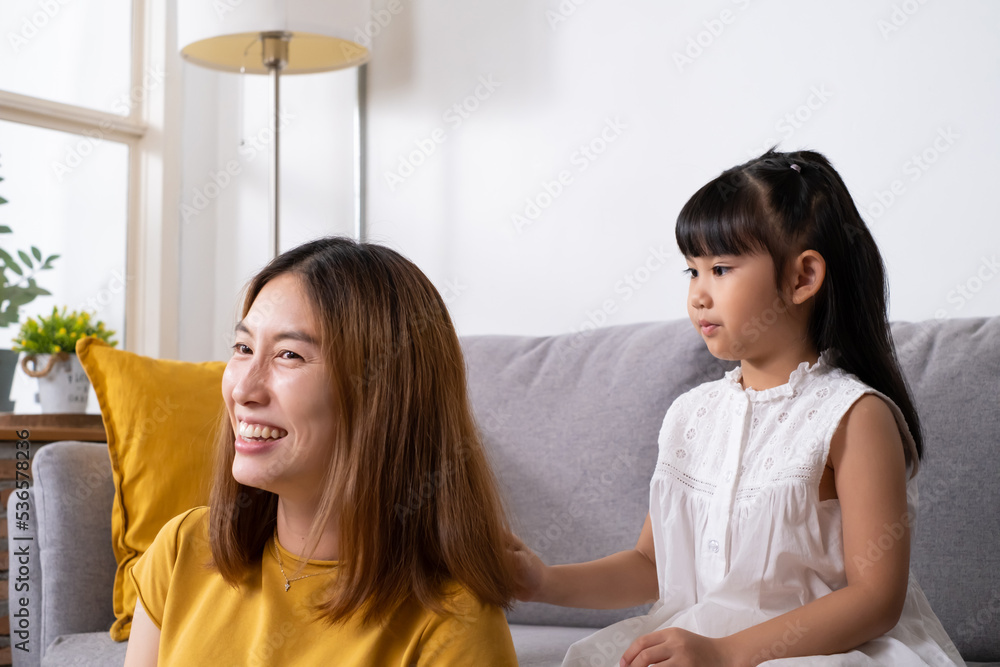 Asian mother and daughter embrace and playing together with happiness and smile inside of living room. Mom and children relationship positive emotion with copy space for text. Asian mother and daughter embrace and playing together with happiness and smile inside of living room. Mom and children relationship positive emotion with copy space for text.