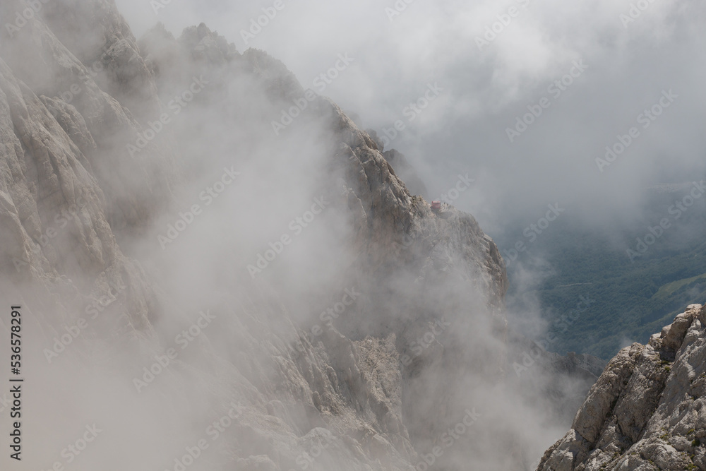 View of the peak of Corno Grande in the Gran Sasso d'Italia massif with fog in Abruzzo
