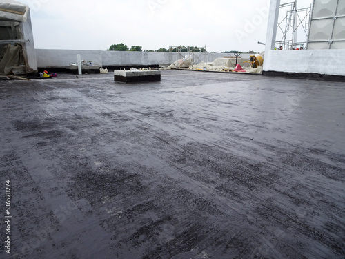 Konstfotografi MELAKA, MALAYSIA -JULY 1, 2022: Waterproofing membrane applied by construction workers on top of the concrete slab