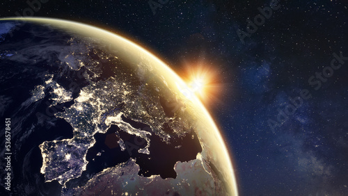 Sunrise on planet Earth viewed from space with city lights in Europe showing connections between European countries. Elements from NASA. Technology, global communication, world, energy, electricity.