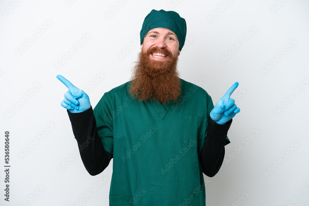 Surgeon redhead man in green uniform isolated on white background pointing finger to the laterals and happy Surgeon redhead man in green uniform isolated on white background pointing finger to the laterals and happy