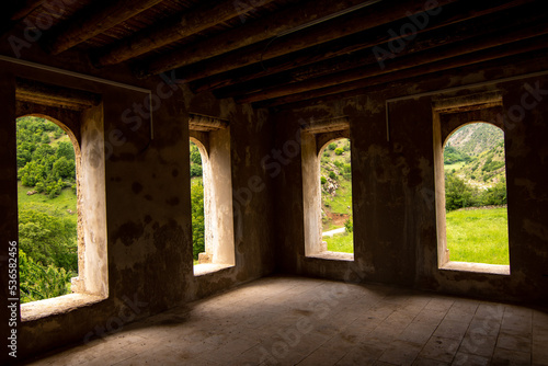 Big windows of historic stone mansion. Nature view from the window 