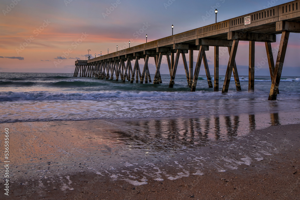 North Carolina beach pier with reflections at sunrise